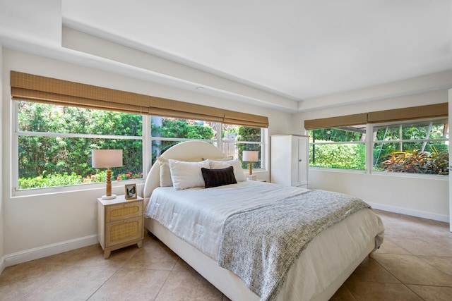 330 SE 7th Ave, Delray Beach, FL 33483 - bedroom with baseboards, light tile patterned floors, and a raised ceiling