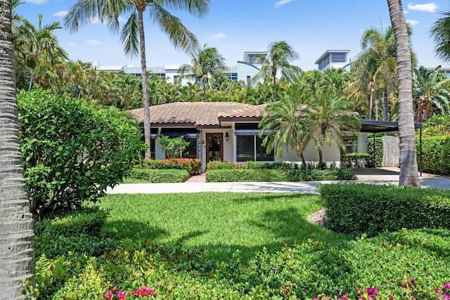 330 SE 7th Ave, Delray Beach, FL 33483 - view of front facade with a front yard, stucco siding, and a tiled roof
