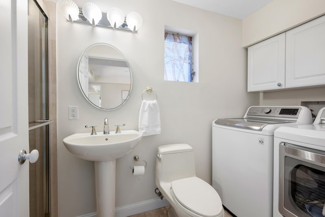 330 SE 7th Ave, Delray Beach, FL 33483 - bathroom with washing machine and dryer, toilet, and baseboards