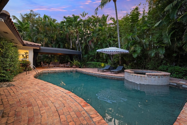 330 SE 7th Ave, Delray Beach, FL 33483 - pool at dusk with a patio area and a pool with connected hot tub