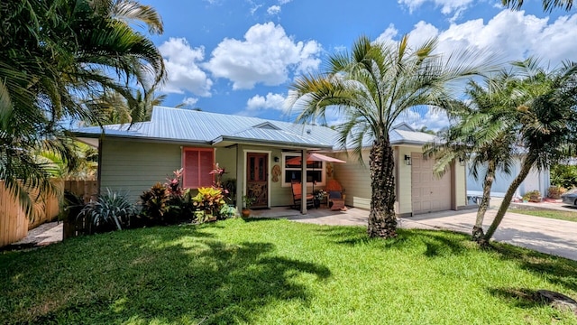 3725 SE Middle St, Stuart, FL 34997 - view of front of home featuring an attached garage, concrete driveway, and metal roof