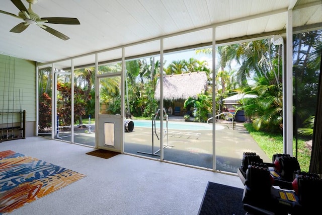 3725 SE Middle St, Stuart, FL 34997 - doorway to outside featuring ceiling fan, floor to ceiling windows, and carpet floors