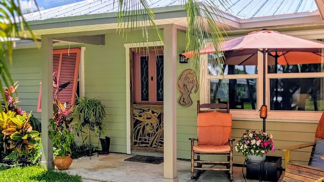 3725 SE Middle St, Stuart, FL 34997 - doorway to property featuring metal roof