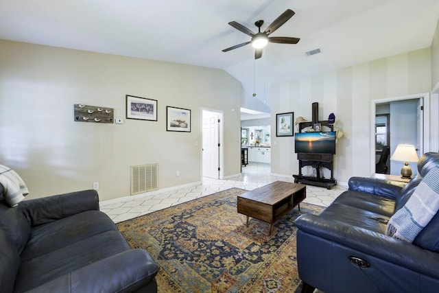 3725 SE Middle St, Stuart, FL 34997 - living room with lofted ceiling, ceiling fan, light tile patterned floors, and baseboards