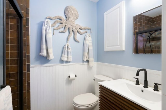 3725 SE Middle St, Stuart, FL 34997 - full bath with wainscoting, toilet, tiled shower, vanity, and radiator heating unit