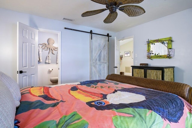 3725 SE Middle St, Stuart, FL 34997 - bedroom featuring a barn door, connected bathroom, and a ceiling fan