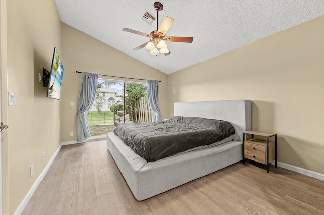 6815 NW 28th St, Margate, FL 33063 - bedroom with access to exterior, light wood-style floors, baseboards, a ceiling fan, and a textured ceiling