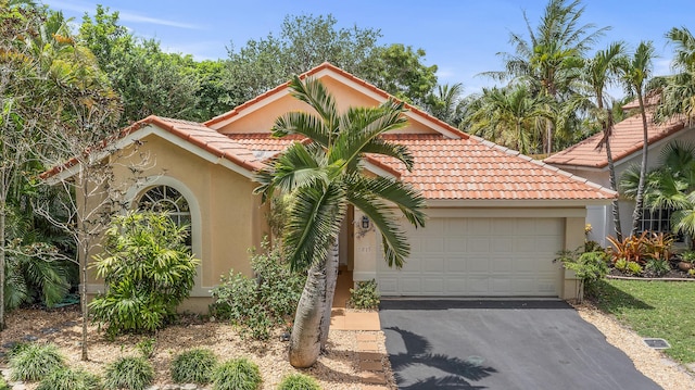 6815 NW 28th St, Margate, FL 33063 - mediterranean / spanish house with a tile roof, stucco siding, driveway, and a garage