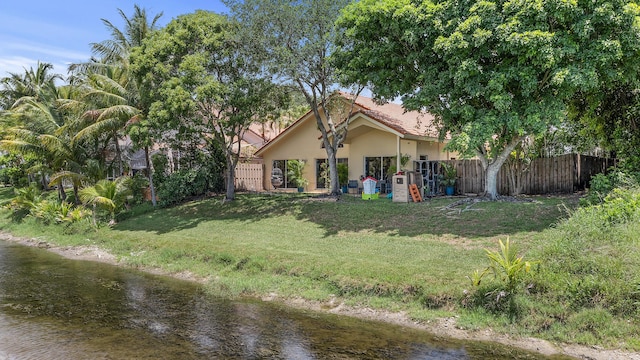 6815 NW 28th St, Margate, FL 33063 - view of front of house with stucco siding and a water view