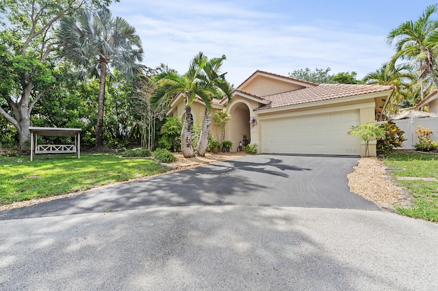 6815 NW 28th St, Margate, FL 33063 - view of front of home with asphalt driveway, stucco siding, a garage, and a tile roof