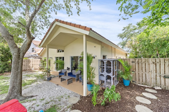 6815 NW 28th St, Margate, FL 33063 - rear view of property with a patio, a fenced backyard, stucco siding, and a tiled roof