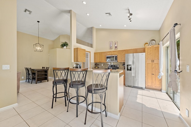 6815 NW 28th St, Margate, FL 33063 - kitchen with appliances with stainless steel finishes, a kitchen breakfast bar, light tile patterned floors, high vaulted ceiling, and decorative backsplash