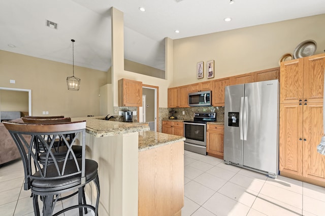 6815 NW 28th St, Margate, FL 33063 - kitchen with stainless steel appliances, high vaulted ceiling, backsplash, a breakfast bar area, and light stone countertops