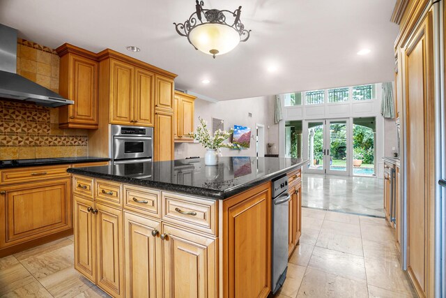434 NW 7th Ave, Boca Raton, FL 33486 - kitchen featuring wall chimney range hood, french doors, double oven, decorative backsplash, and a center island