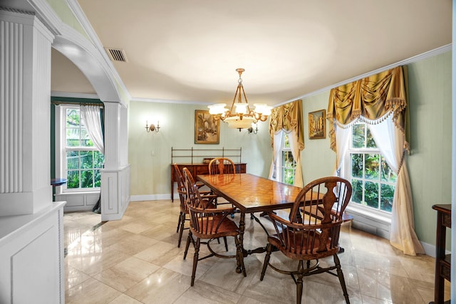 434 NW 7th Ave, Boca Raton, FL 33486 - dining room with decorative columns, ornamental molding, a chandelier, arched walkways, and baseboards