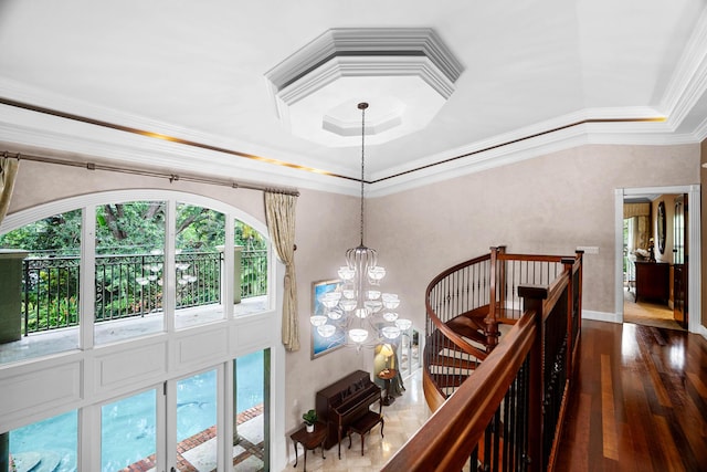 434 NW 7th Ave, Boca Raton, FL 33486 - staircase with a chandelier, a raised ceiling, hardwood / wood-style floors, crown molding, and baseboards
