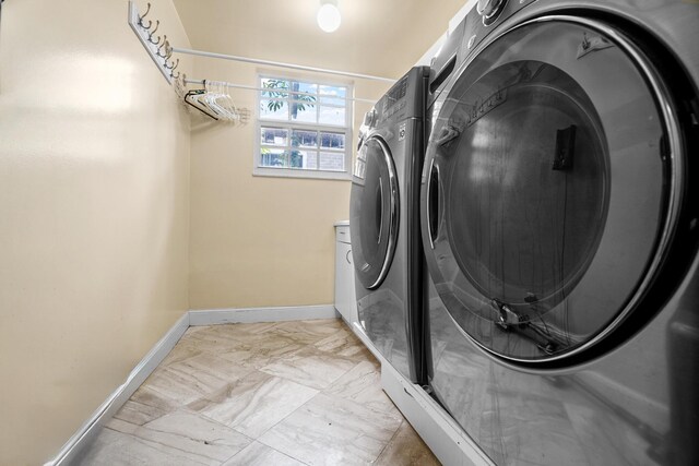 434 NW 7th Ave, Boca Raton, FL 33486 - laundry area with independent washer and dryer, baseboards, and light marble finish floors