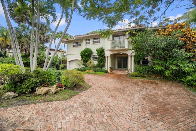 434 NW 7th Ave, Boca Raton, FL 33486 - mediterranean / spanish-style house with french doors, a balcony, stucco siding, and an attached garage