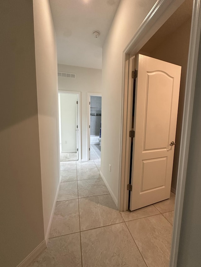 1517 SW Bayshore Blvd, Port Saint Lucie, FL 34983 - corridor with light tile patterned flooring and baseboards