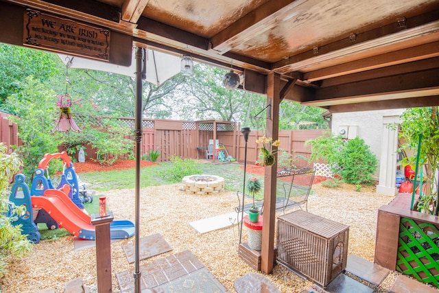 6160 31st Ter NW, Fort Lauderdale, FL 33309 - fenced backyard featuring an outdoor fire pit, a patio area, and a playground