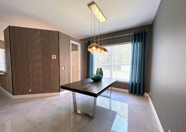 8825 Gibson Cay, West Palm Beach, FL 33411 - dining room featuring baseboards, tile patterned floors, and a textured ceiling