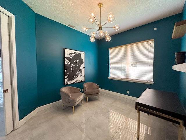 8825 Gibson Cay, West Palm Beach, FL 33411 - sitting room with a chandelier, a textured ceiling, and baseboards
