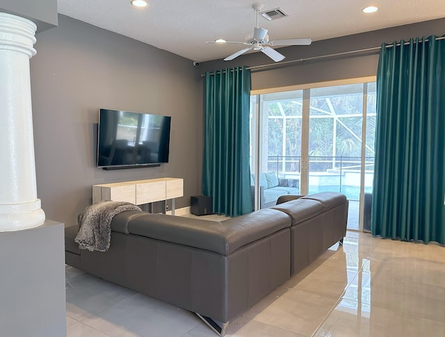 8825 Gibson Cay, West Palm Beach, FL 33411 - living room featuring ornate columns, a ceiling fan, recessed lighting, light tile patterned floors, and a textured ceiling