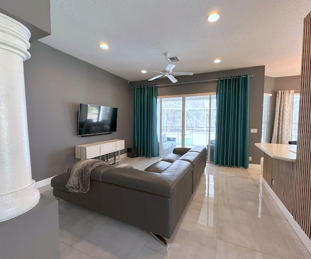 8825 Gibson Cay, West Palm Beach, FL 33411 - living area with baseboards, healthy amount of natural light, recessed lighting, ornate columns, and a textured ceiling