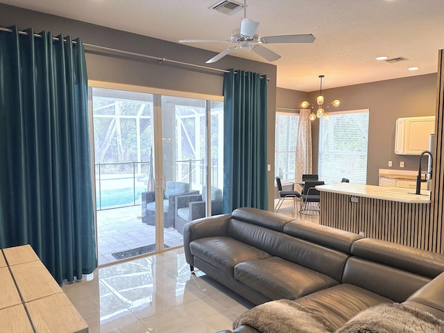 8825 Gibson Cay, West Palm Beach, FL 33411 - living room with ceiling fan, a chandelier, and recessed lighting