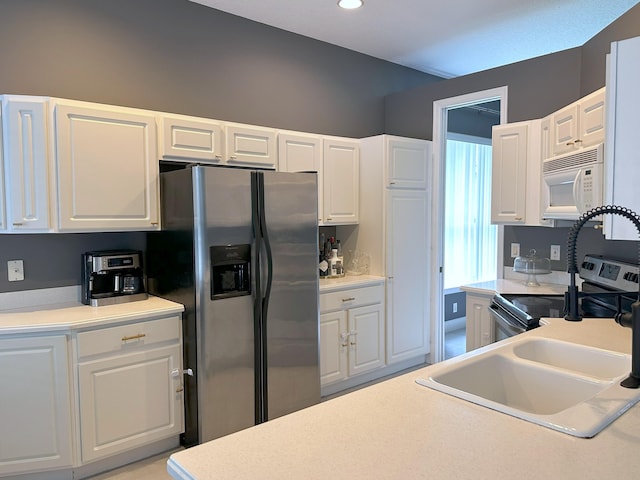 8825 Gibson Cay, West Palm Beach, FL 33411 - kitchen featuring appliances with stainless steel finishes, white cabinetry, light countertops, a sink, and recessed lighting