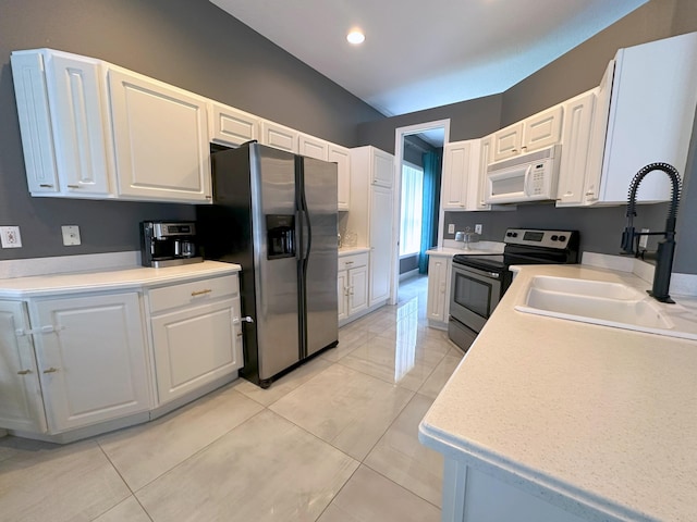 8825 Gibson Cay, West Palm Beach, FL 33411 - kitchen with stainless steel appliances, a sink, white cabinets, light countertops, and recessed lighting