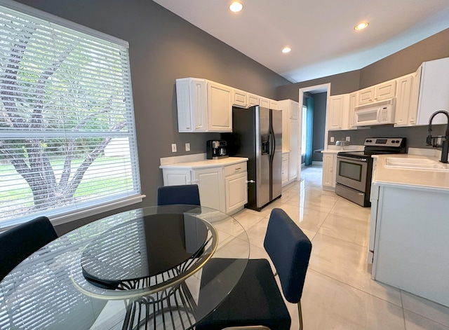 8825 Gibson Cay, West Palm Beach, FL 33411 - kitchen featuring stainless steel appliances, a sink, light countertops, white cabinets, and recessed lighting
