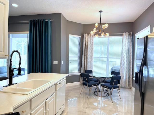 8825 Gibson Cay, West Palm Beach, FL 33411 - kitchen featuring refrigerator with ice dispenser, white dishwasher, a sink, a chandelier, and baseboards