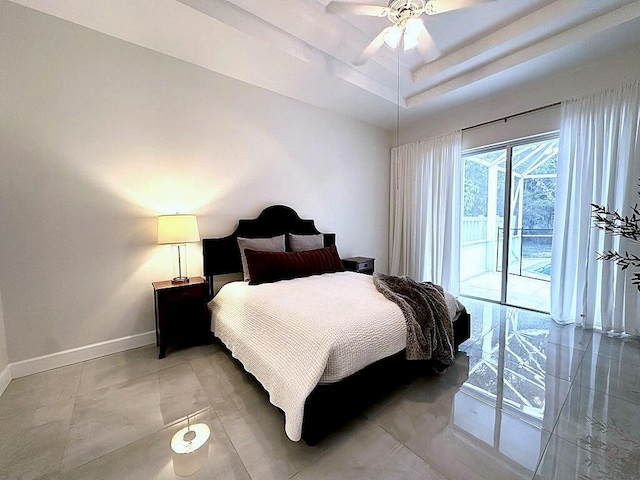 8825 Gibson Cay, West Palm Beach, FL 33411 - bedroom with access to exterior, baseboards, a ceiling fan, a tray ceiling, and light tile patterned flooring