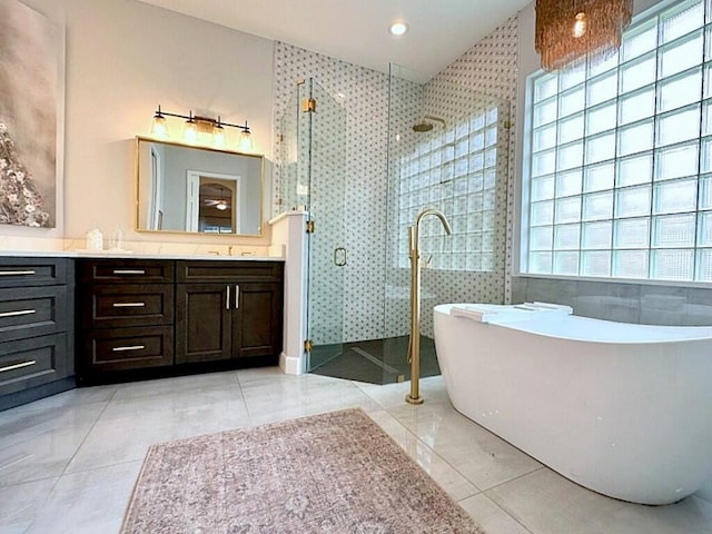 8825 Gibson Cay, West Palm Beach, FL 33411 - bathroom with a shower stall, vanity, a freestanding bath, and tile patterned floors