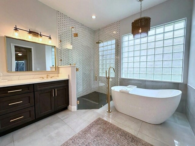 8825 Gibson Cay, West Palm Beach, FL 33411 - full bathroom with plenty of natural light, a shower stall, vanity, and a freestanding tub
