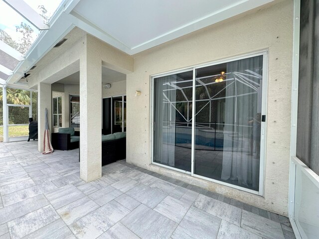 8825 Gibson Cay, West Palm Beach, FL 33411 - view of patio with outdoor lounge area and a lanai