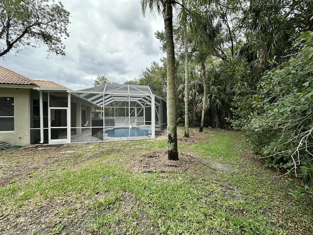 8825 Gibson Cay, West Palm Beach, FL 33411 - view of grassy yard featuring an outdoor pool and a lanai