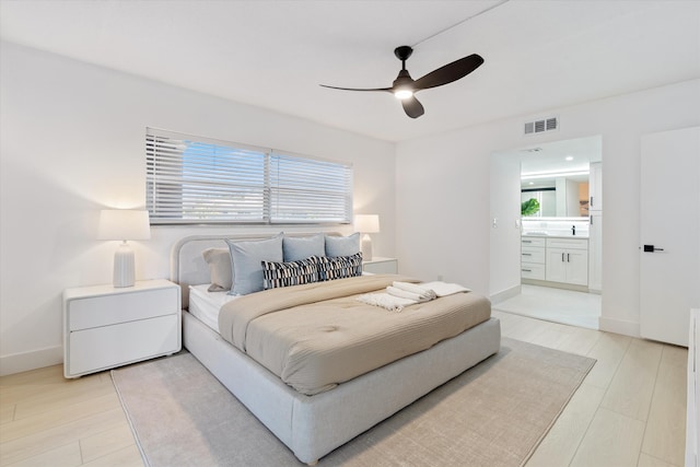 700 NE Harbour Ter Unit 3320, Boca Raton, FL 33431 - bedroom featuring light wood-style flooring, ensuite bathroom, a ceiling fan, and baseboards