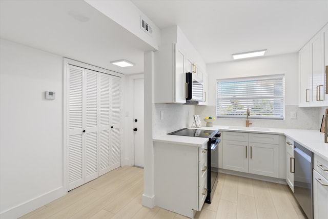 700 NE Harbour Ter Unit 3320, Boca Raton, FL 33431 - kitchen featuring stainless steel appliances, a sink, light wood-type flooring, and tasteful backsplash