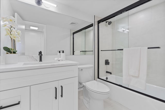 700 NE Harbour Ter Unit 3320, Boca Raton, FL 33431 - bathroom featuring toilet, vanity, combined bath / shower with glass door, and tile patterned flooring