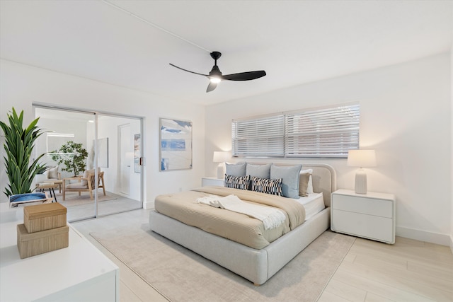 700 NE Harbour Ter Unit 3320, Boca Raton, FL 33431 - bedroom with access to outside, ceiling fan, baseboards, and light wood-type flooring
