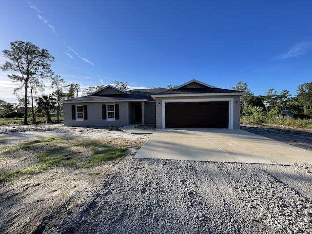 15362 67th Ct N, Loxahatchee, FL 33470 - ranch-style house featuring concrete driveway, a garage, and stucco siding