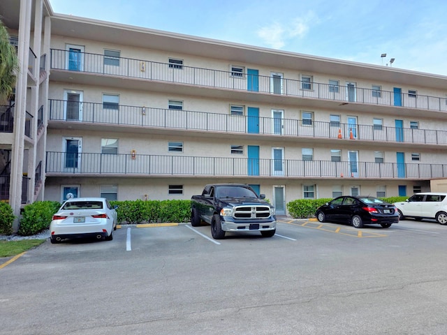 725 Lori Dr Unit 206, Palm Springs, FL 33406 - view of apartment building / complex featuring uncovered parking