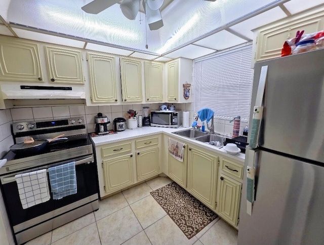 725 Lori Dr Unit 206, Palm Springs, FL 33406 - kitchen featuring stainless steel appliances, under cabinet range hood, cream cabinets, a sink, and light tile patterned floors