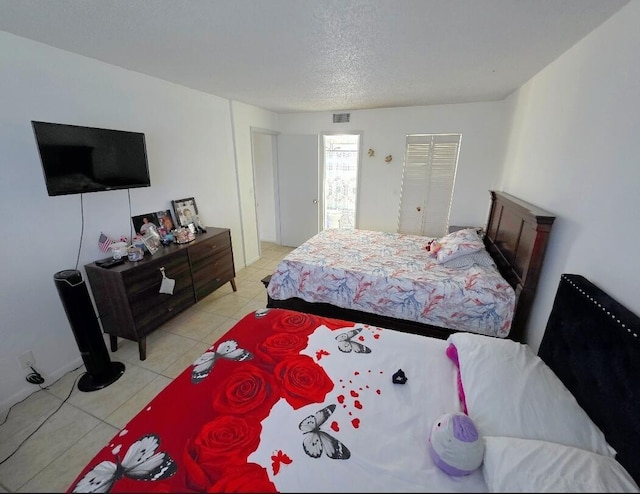 725 Lori Dr Unit 206, Palm Springs, FL 33406 - bedroom with light tile patterned floors and a textured ceiling