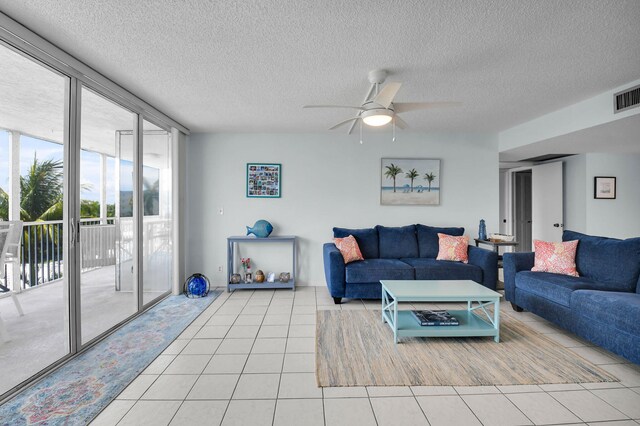 1 Harbourside Dr Unit 4506, Delray Beach, FL 33483 - living room featuring a wall of windows, light tile patterned floors, a textured ceiling, and ceiling fan