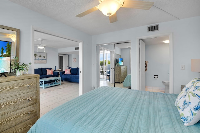 1 Harbourside Dr Unit 4506, Delray Beach, FL 33483 - bedroom with light tile patterned floors, ceiling fan, a closet, ensuite bath, and a textured ceiling