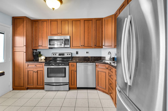 1 Harbourside Dr Unit 4506, Delray Beach, FL 33483 - kitchen with appliances with stainless steel finishes, brown cabinetry, a sink, and light tile patterned flooring