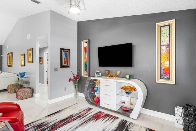 7685 Springwater Pl Unit 201, Boynton Beach, FL 33437 - living room featuring vaulted ceiling, light tile patterned floors, and baseboards